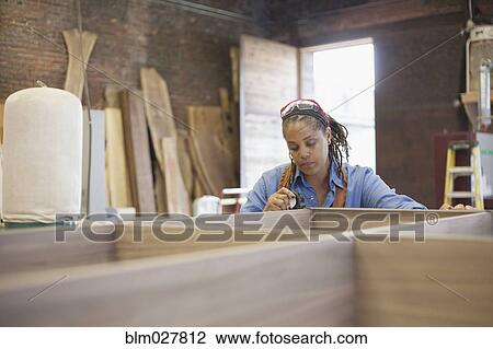 Black carpenter working in workshop View Large Photo Image Stock Image - Black carpenter working in workshop. Fotosearch