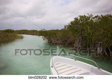 Boat floating in rural river View Large Photo Image Stock Image - Boat floating in rural river. Fotosearch