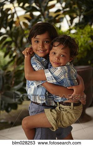 Boy holding brother on porch View Large Photo Image Stock Image - Boy holding brother on porch. Fotosearch