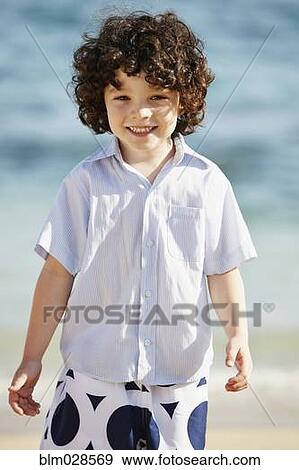 Stock Photo - Boy smiling on beach. Fotosearch
