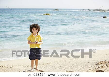 Boy standing on beach View Large Photo Image Picture - Boy standing on beach. Fotosearch