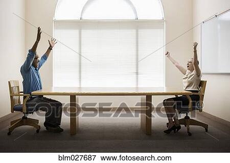Business people cheering in office View Large Photo Image Stock Photo - Business people cheering in office. Fotosearch