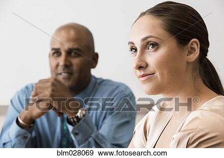 Business people listening in meeting View Large Photo Image Stock Photo - Business people listening in meeting. Fotosearch
