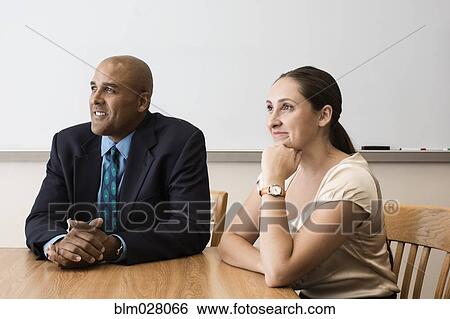 Business people listening in meeting View Large Photo Image Stock Photograph - Business people listening in meeting. Fotosearch