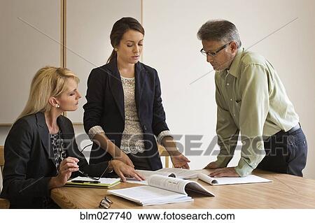 Stock Image - Business people talking in meeting. Fotosearch