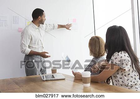Stock Photo - Business people talking in meeting. Fotosearch