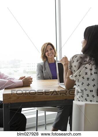 Stock Photo - Business people talking in meeting. Fotosearch