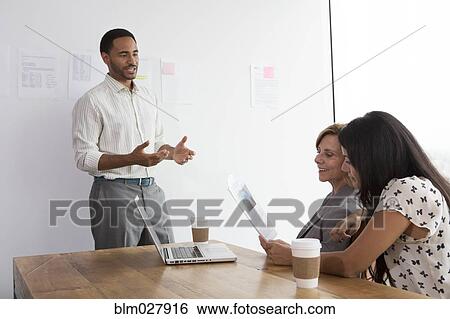 Stock Photograph - Business people talking in meeting. Fotosearch