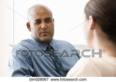 Business people talking in office View Large Photo Image Stock Photo - Business people talking in office. Fotosearch