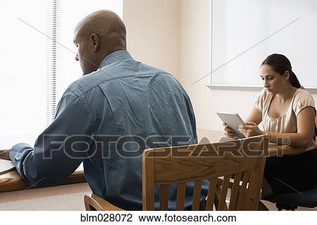 Stock Image - Business people working in office. Fotosearch