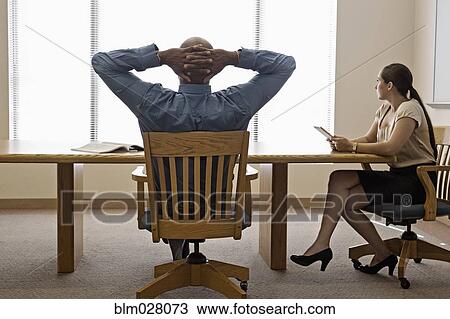 Stock Image - Business people working in office. Fotosearch