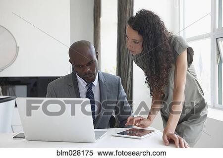 Stock Photography - Business people working in office. Fotosearch