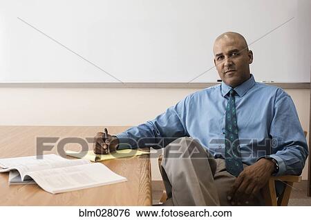 Stock Photograph - Businessman making notes in office. Fotosearch