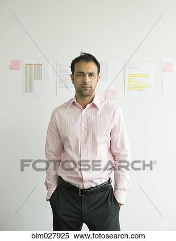 Stock Photography - Businessman standing in office. Fotosearch