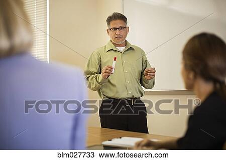 Businessman talking in meeting View Large Photo Image Stock Image - Businessman talking in meeting. Fotosearch