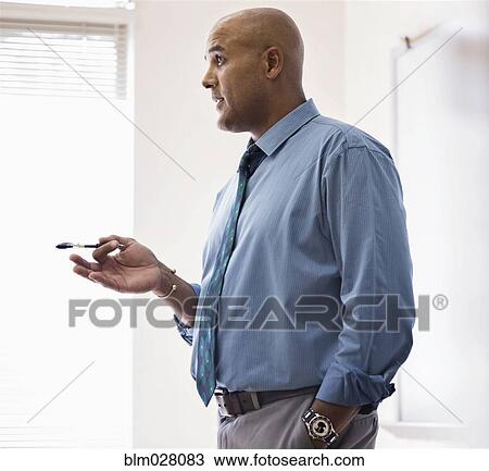 Businessman talking in office View Large Photo Image Stock Image - Businessman talking in office. Fotosearch