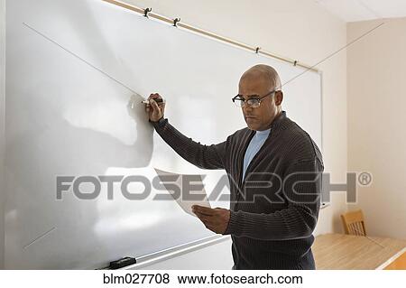 Businessman writing on whiteboard View Large Photo Image Stock Photo - Businessman writing on whiteboard. Fotosearch