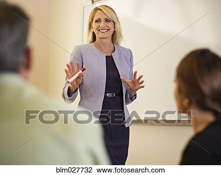 Stock Image - Businesswoman talking in meeting. Fotosearch