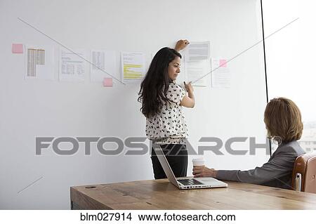 Picture - Businesswomen talking in office. Fotosearch