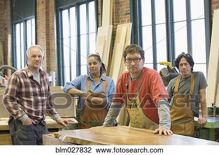 Stock Image - Carpenters in workshop. Fotosearch