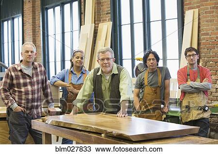 Stock Image - Carpenters in workshop. Fotosearch