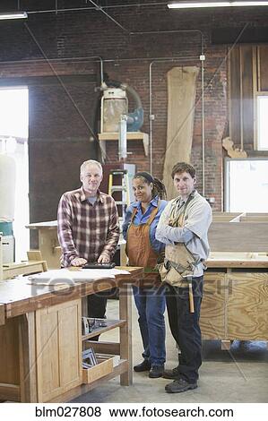 Stock Photo - Carpenters smiling in workshop. Fotosearch