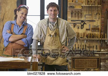 Stock Photo - Carpenters smiling in workshop. Fotosearch