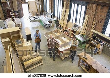 Stock Photography - Carpenters smiling in workshop. Fotosearch