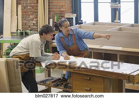 Stock Photo - Carpenters talking in workshop. Fotosearch