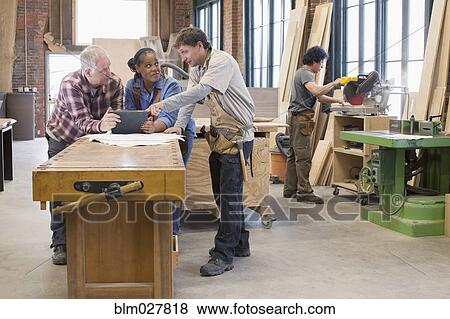 Carpenters using digital tablet in workshop View Large Photo Image Stock Photo - Carpenters using digital tablet in workshop. Fotosearch