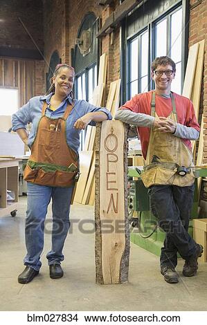 Carpenters with carved Open sign in workshop View Large Photo Image Picture - Carpenters with carved Open sign in workshop. Fotosearch
