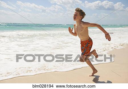 Caucasian boy running on beach View Large Photo Image Picture - Caucasian boy running on beach. Fotosearch