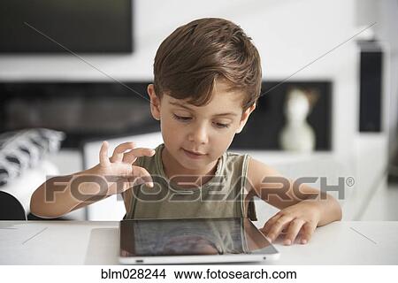 Caucasian boy using digital tablet View Large Photo Image Picture - Caucasian boy using digital tablet. Fotosearch