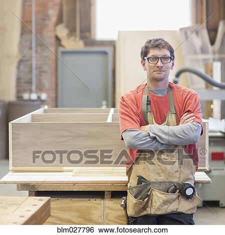 Caucasian carpenter smiling in workshop View Large Photo Image Stock Photograph - Caucasian carpenter smiling in workshop. Fotosearch