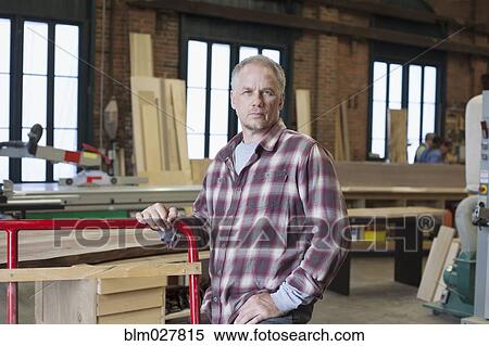 Caucasian carpenter standing in workshop View Large Photo Image Stock Photography - Caucasian carpenter standing in workshop. Fotosearch