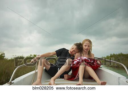 Caucasian children sitting on boat View Large Photo Image Stock Photography - Caucasian children sitting on boat. Fotosearch