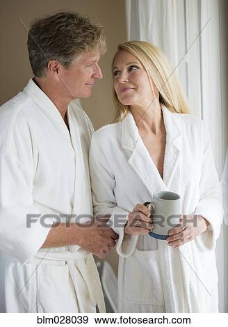 Caucasian couple having coffee in bathrobes View Large Photo Image Stock Photo - Caucasian couple having coffee in bathrobes. Fotosearch