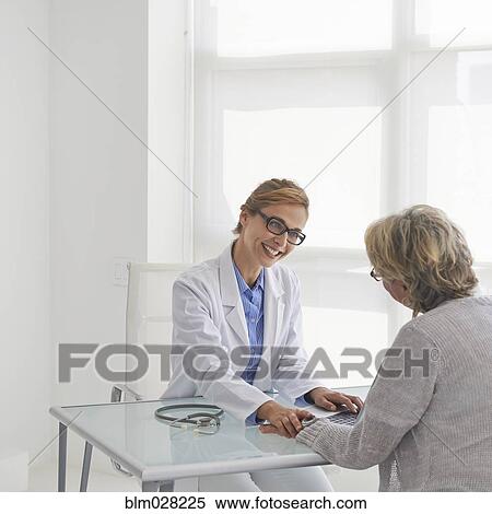 Caucasian doctor and patient talking in office View Large Photo Image Stock Photography - Caucasian doctor and patient talking in office. Fotosearch