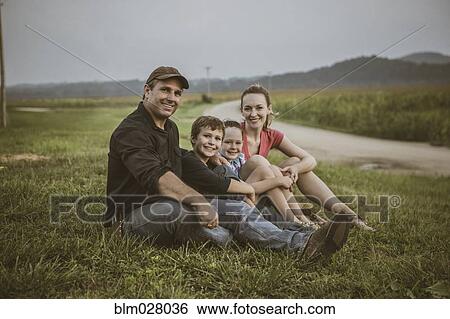 Stock Photograph - Caucasian family overlooking crop fields. Fotosearch