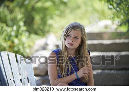 Caucasian girl sitting outdoors View Large Photo Image Stock Image - Caucasian girl sitting outdoors. Fotosearch