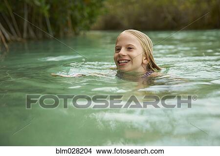 Picture - Caucasian girl swimming in river. Fotosearch