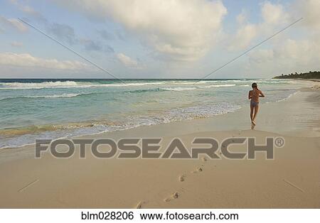 Caucasian girl walking on beach View Large Photo Image Stock Photograph - Caucasian girl walking on beach. Fotosearch