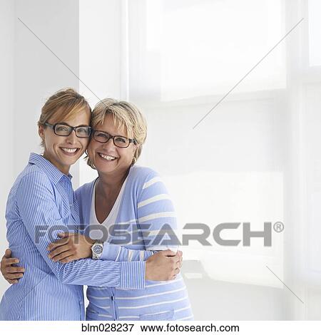 Caucasian mother and daughter hugging View Large Photo Image Stock Photo - Caucasian mother and daughter hugging. Fotosearch