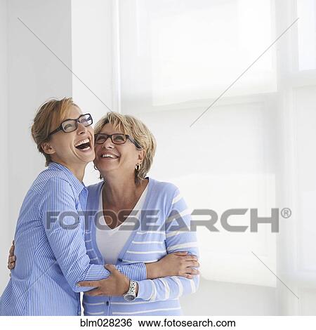 Stock Photograph - Caucasian mother and daughter hugging. Fotosearch