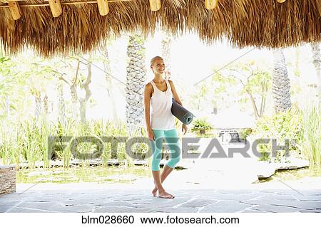 Caucasian woman carrying yoga mat View Large Photo Image Stock Image - Caucasian woman carrying yoga mat. Fotosearch