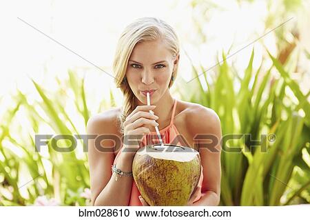 Caucasian woman drinking from coconut View Large Photo Image Stock Image - Caucasian woman drinking from coconut. Fotosearch