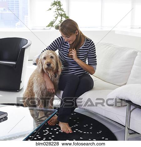 Caucasian woman hugging dog in living room View Large Photo Image Stock Photo - Caucasian woman hugging dog in living room. Fotosearch