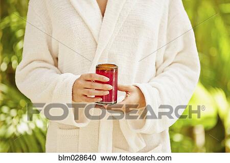 Caucasian woman in bathrobe holding glass of juice View Large Photo Image Stock Image - Caucasian woman in bathrobe holding glass of juice. Fotosearch