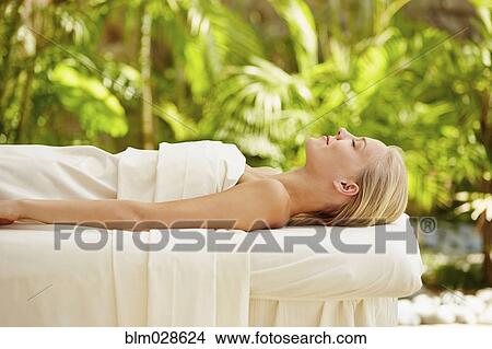 Caucasian woman laying on massage table View Large Photo Image Picture - Caucasian woman laying on massage table. Fotosearch