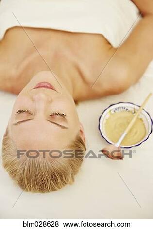 Stock Photo - Caucasian woman laying on massage table. Fotosearch